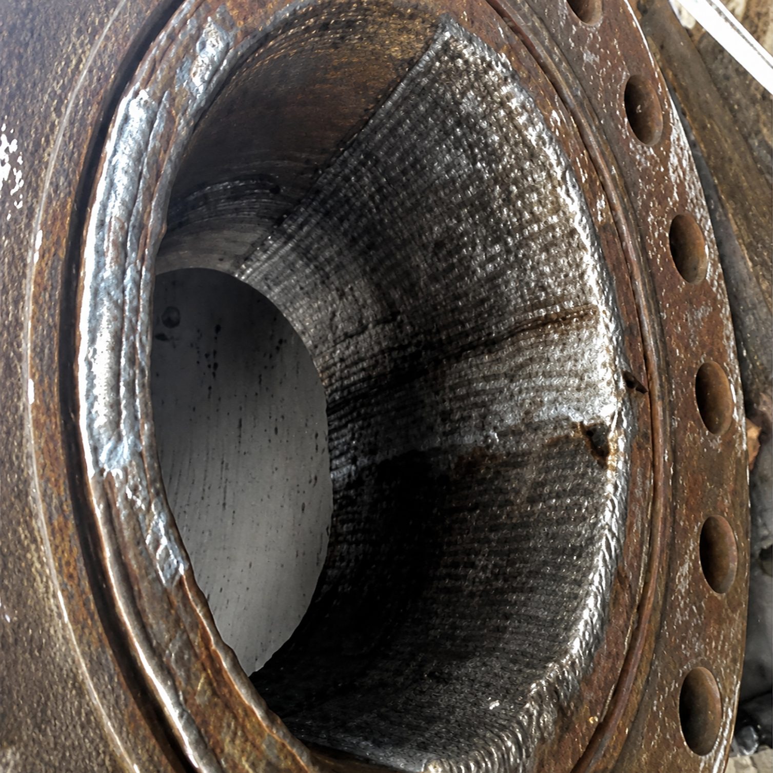 Worker inspecting industrial heat exchanger units.